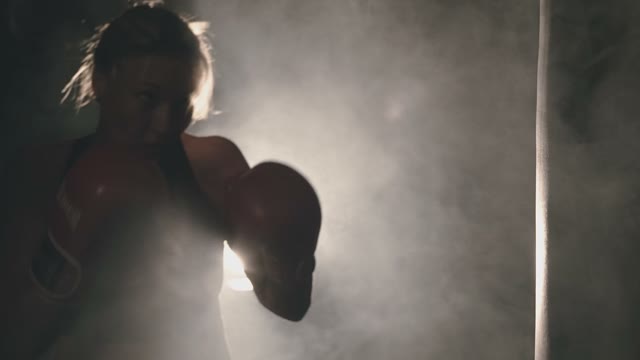 A Young Girl Struggles Hard At The Boxing Club