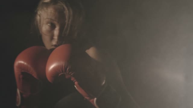 Young Beautiful Girl Exercising In The Boxing Club