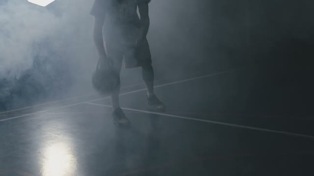 Basketball Player Plays The Ball In His Hands