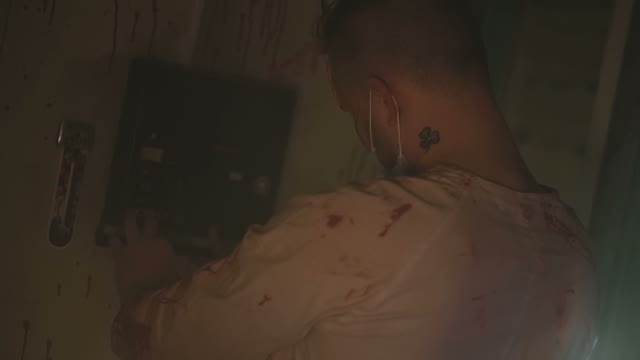 Crazy Serial Maniac Doctor Digging Into An Electronic Device On The Wall