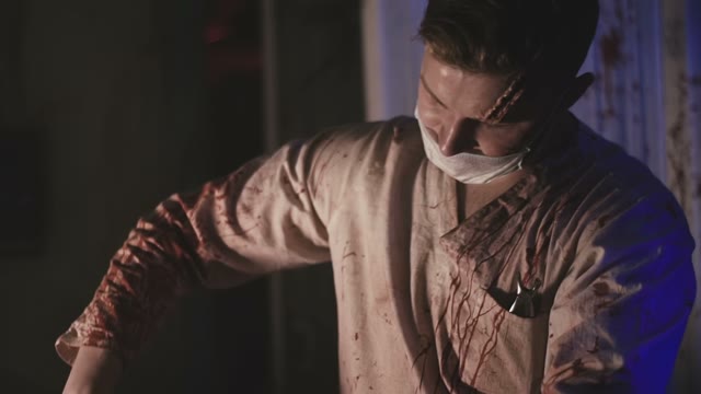 A Mad Doctor In A Bloody Smock Tortures A Human