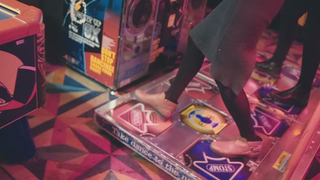 Two Young Attractive Girls Are Dancing On The Dance Machine