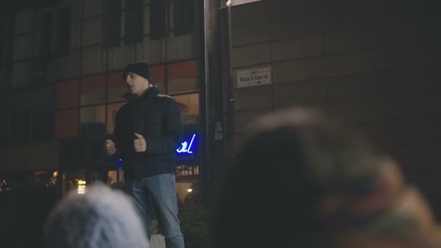 A Young Guy Communicating With People In The Streets Of Prague