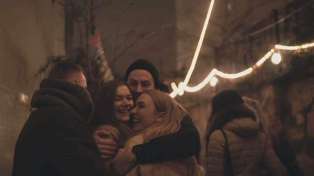 Young Beautiful Girls Hug With Guys In The Streets Of Prague