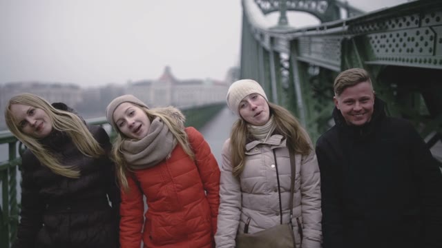 A Group Of Young People Dancing On A Bridge