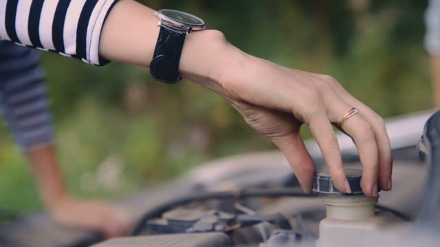 A Woman Is Repairing A Car In The Forest