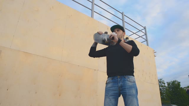 A Young Guy Smokes Standing Next To The Ramp