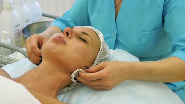 Woman Doing Massage Of Ears Close-up