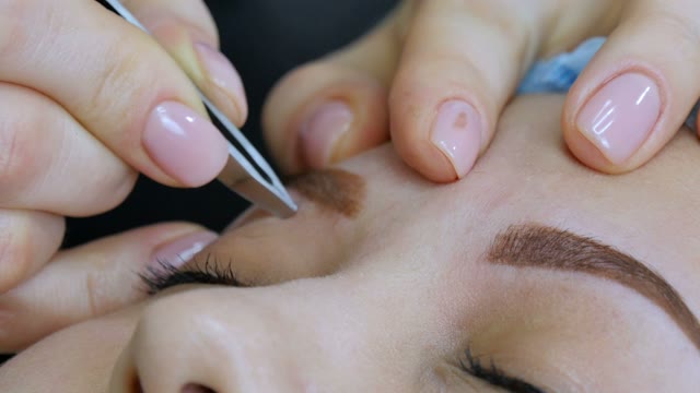 Master Plucks The Eyebrow Of The Girl Close-up