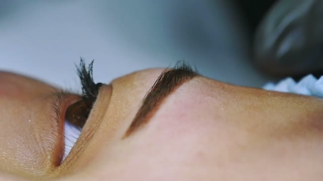 Master Greases The Eyebrow Of A Girl Close-up