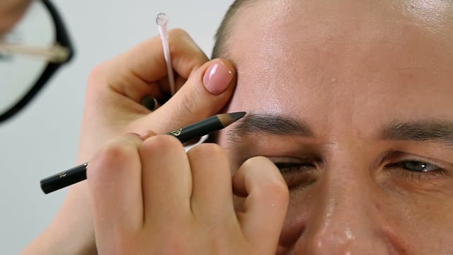 Girl Paints A Man's Eyebrow Close-up