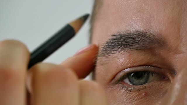 Girl Paints A Man's Eyebrow Close-up