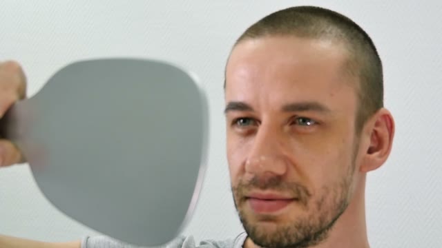 Girl Prepares To Paint A Man's Eyebrows Close-up