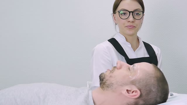Woman In Glasses Prepares To Work With A Man