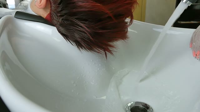 Hairdresser In Gloves Washes Hair Close-up