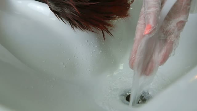Hairdresser In Gloves Washes Hair Close-up