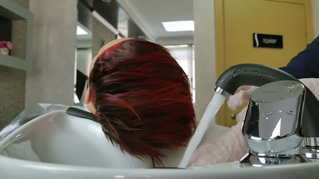 Hairdresser In Gloves Washes Hair Close-up