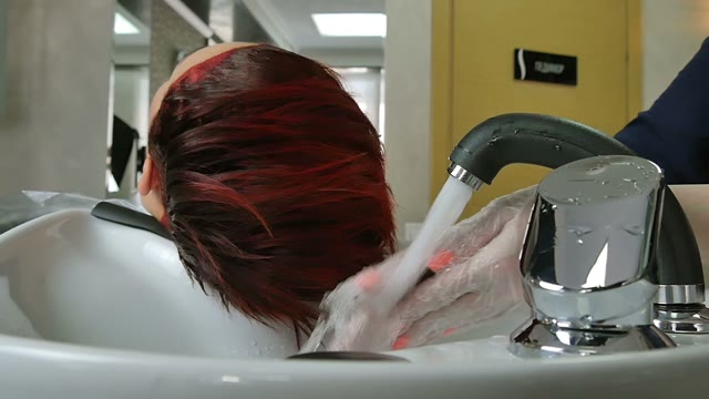 Hairdresser In Gloves Washes Hair Close-up