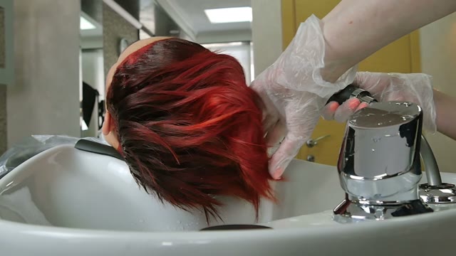 Hairdresser In Gloves Washes Hair Close-up