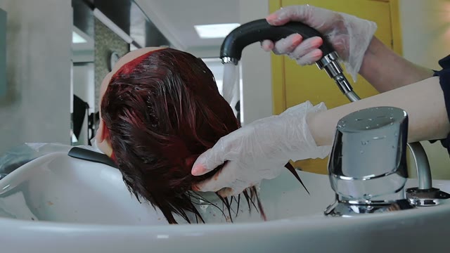 Hairdresser Washes Paint Off Hair Close-up