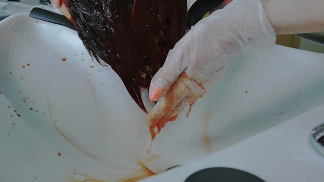 Hairdresser Washes Paint Off Hair Close-up