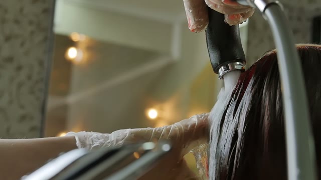 Hairdresser Washes Hair To Woman Close-up