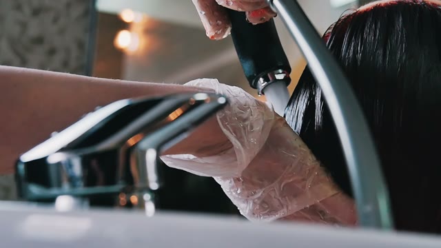 Hairdresser Washes Hair To Woman Close-up