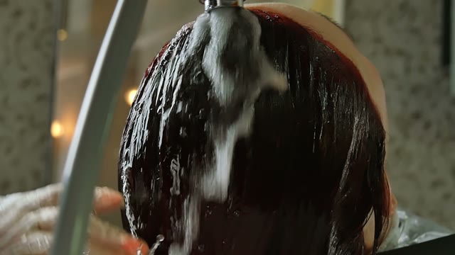 Hairdresser Washes Hair To Woman Close-up