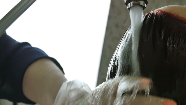Hairdresser In Gloves Washes Hair Close-up