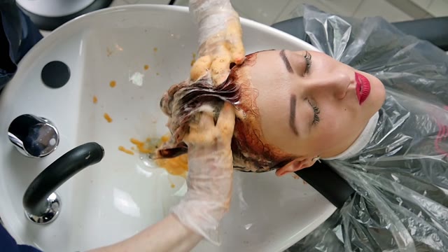 Hairdresser Washes Paint Off Hair Close-up