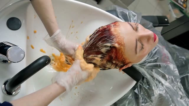 Hairdresser Washes Paint Off Hair Close-up