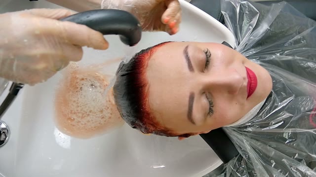 Hairdresser Washes Paint Off Hair Close-up