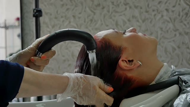 Hairdresser Washes Hair To Woman Close-up