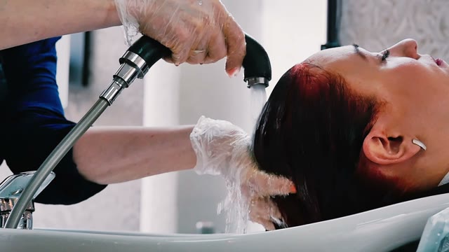 Hairdresser Washes Hair To Woman Close-up