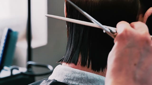 Hairdresser Cuts Hair To The Client Close-up