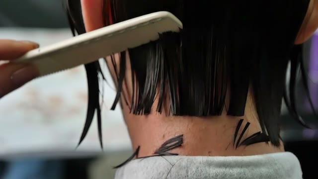 Hairdresser Cuts Hair To The Client Close-up