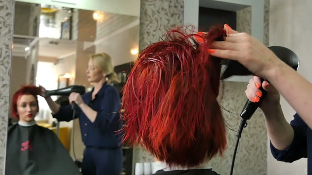 Hairdresser Dries Hair With A Hair Dryer Close-up