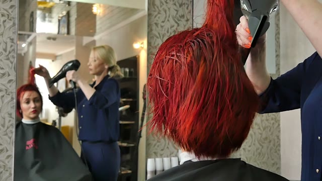 Hairdresser Dries Hair With A Hair Dryer Close-up