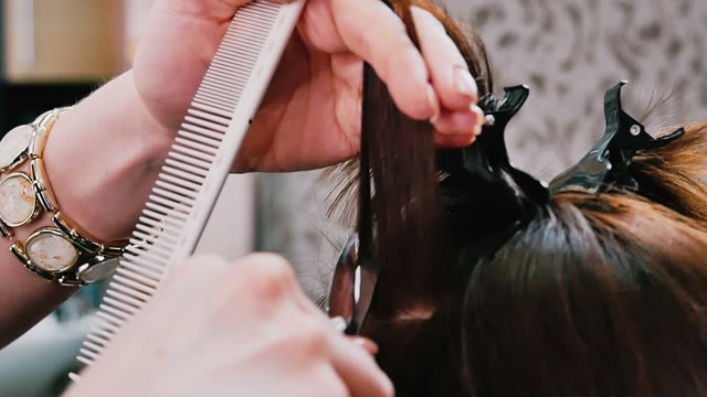 Hairdresser Cuts Hair To The Client Close-up