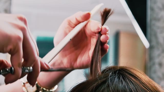 Hairdresser Cuts Hair To The Client Close-up