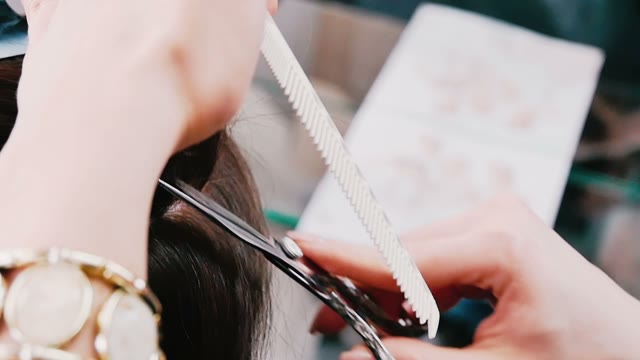 Hairdresser Cuts Hair To The Client Close-up
