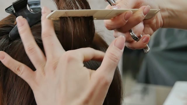 Hairdresser Cuts Hair To The Client Close-up