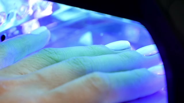 Female Hand In Lamp For Manicure Close-up