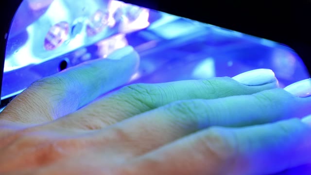 Female Hand In Lamp For Manicure Close-up