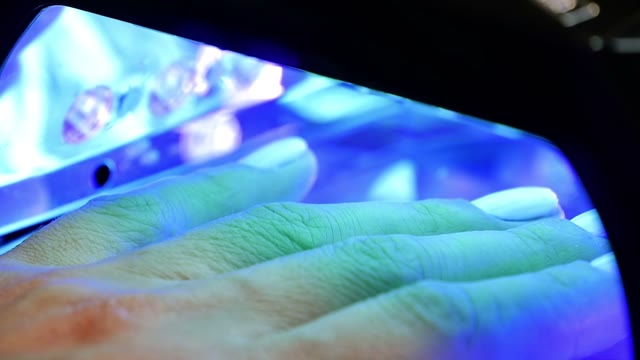 Female Hand In Lamp For Manicure Close-up
