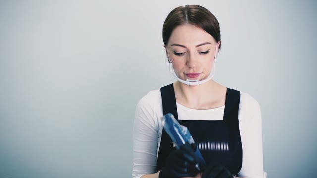 Woman Working With A Tattoo Machine Close-up