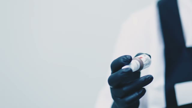 Woman Shakes A Bottle Of Paint Close-up