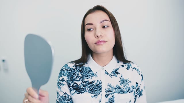 Beautiful Girl Looks In The Mirror