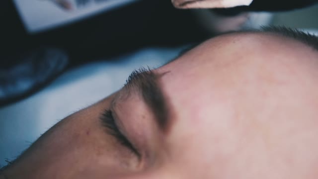 Master Does Tattoo Of Man's Brows Close-up