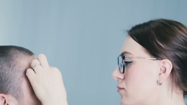 Girl Paints A Man's Eyebrow In Pencil Close-up